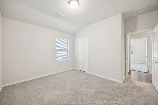 an empty room with windows and closet
