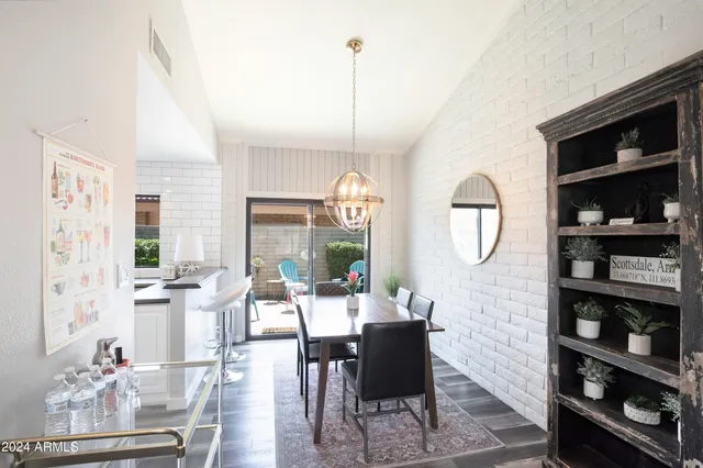 a living room with furniture a mirror and a large window