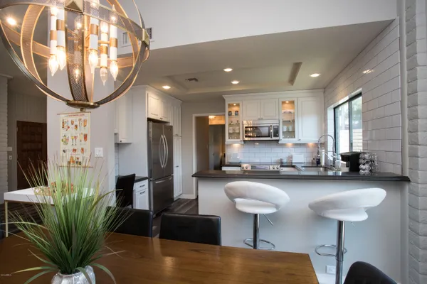 a kitchen with stainless steel appliances granite countertop a stove a sink and a refrigerator