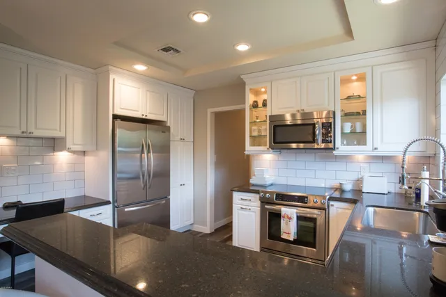 a kitchen with a sink and large window