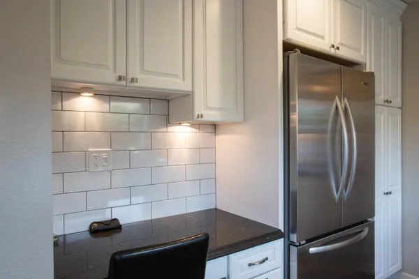 a kitchen with granite countertop a sink and cabinets
