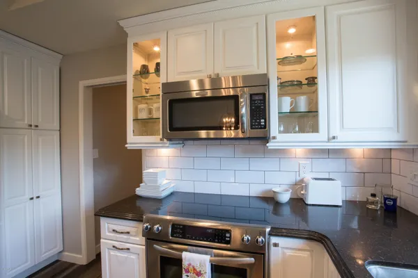 a kitchen with a refrigerator and table