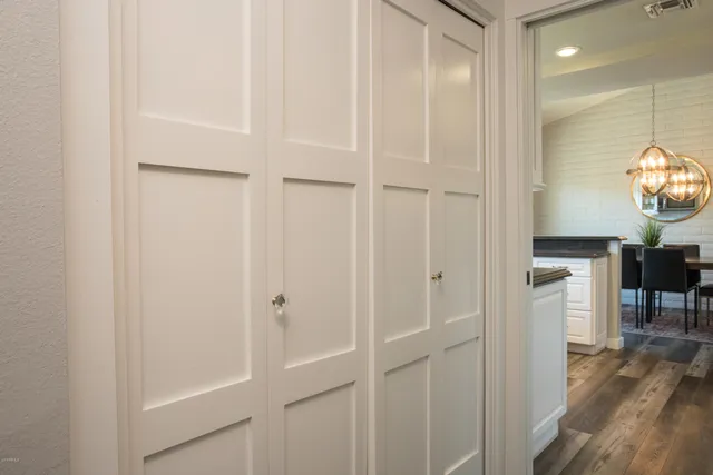 a view of a hallway with wooden floor and entryway