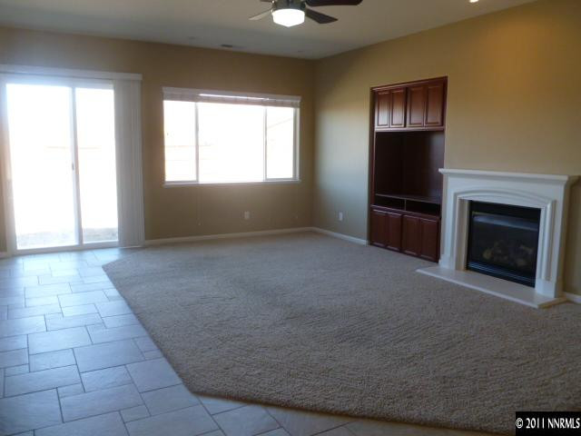 10122 Golden Spur Court Reno, NV 89521 - Photo 4 of 13 a view of empty room with a fireplace and windows