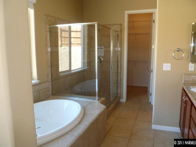 10122 Golden Spur Court Reno, NV 89521 - Photo 6 of 13 a bathroom with a tub and shower