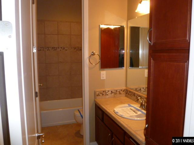10122 Golden Spur Court Reno, NV 89521 - Photo 8 of 13 a bathroom with a granite countertop sink and shower