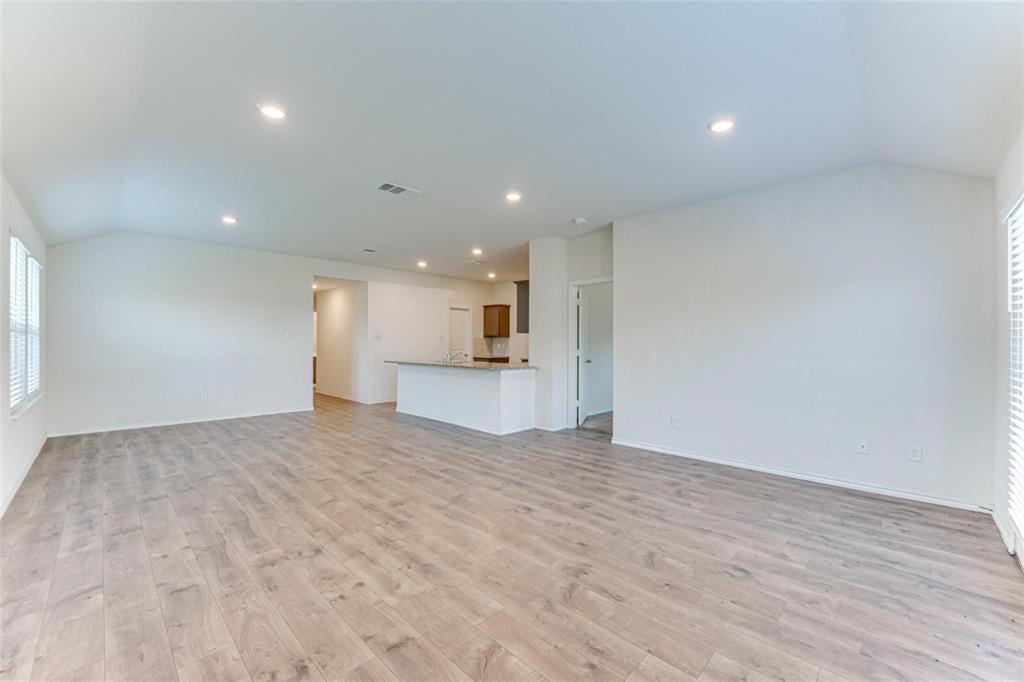 517 Milo Way Royse City, TX 75189 - Photo 28 of 34 Spacious room featuring wood-finish flooring, recessed lighting, and white walls