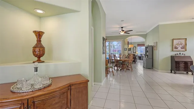 a open kitchen with stainless steel appliances granite countertop a stove a sink dishwasher a dining table and chair with wooden floor