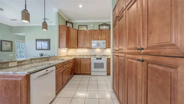 a living room with furniture flowerpot and a mirror