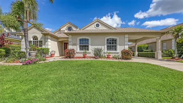 an aerial view of a house with a garden and lake view