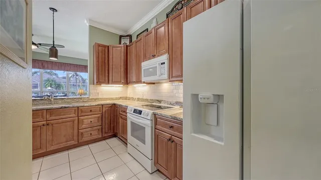 a dining room with furniture a chandelier and window