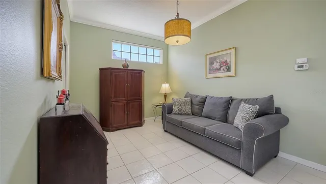 a bedroom with a bed couch and dresser