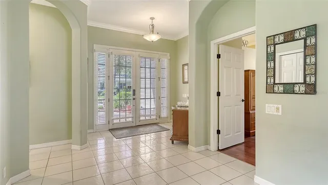 a dining room with furniture a chandelier and wooden floor