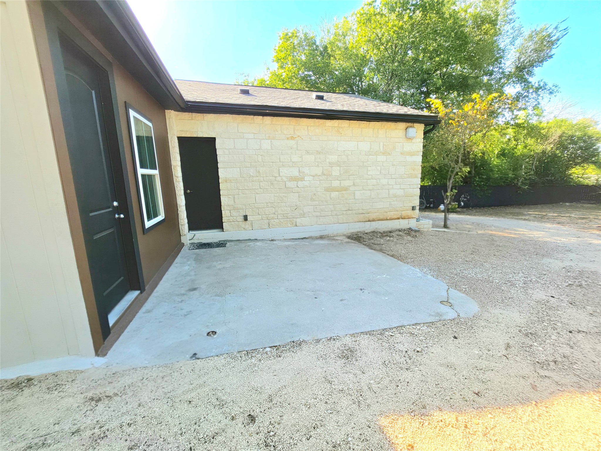 2201 Teri Road Austin, TX 78744 - Photo 28 of 40 Solid stone masonry and concrete surfaces frame this versatile outdoor space.