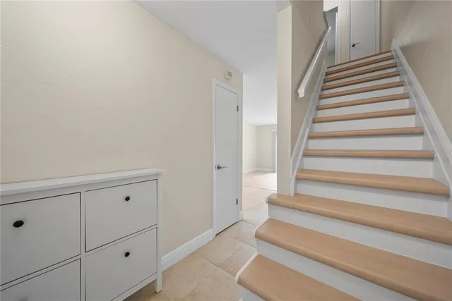 a hallway with white walls and wooden floor