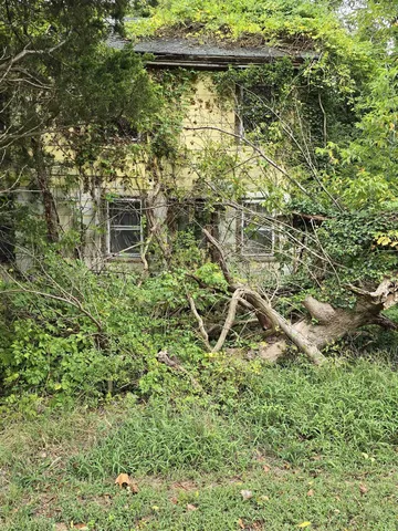 a backyard of a house with table and chairs
