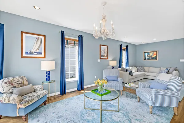 a living room with furniture and a chandelier