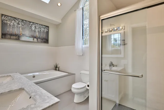 a white toilet sitting next to a bathroom sink