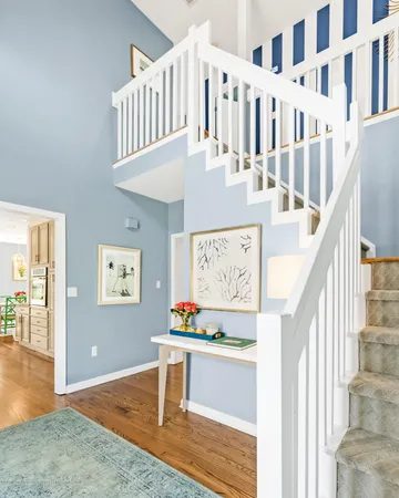 a view of staircase with furniture and wooden floor
