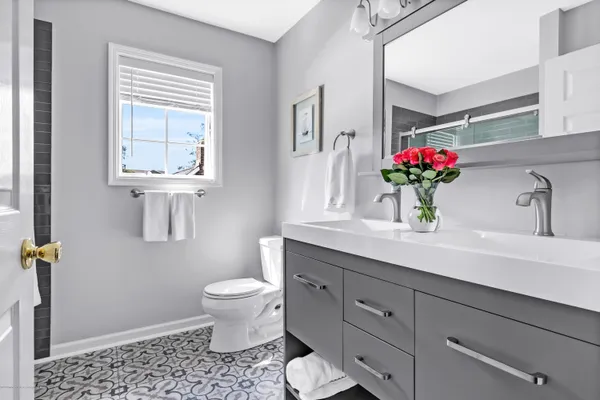 a bathroom with a toilet sink and mirror