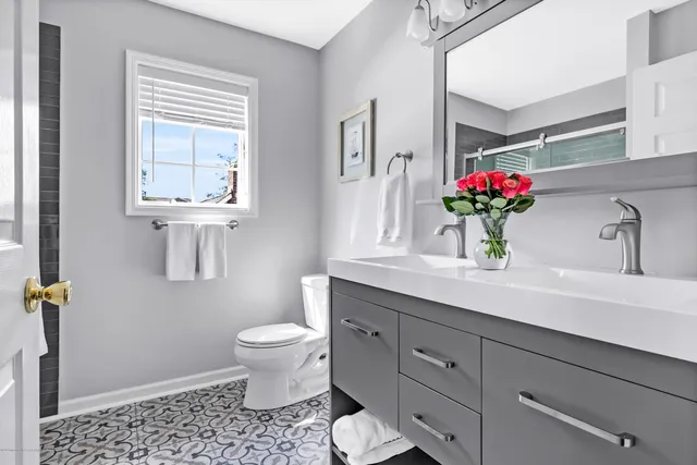 a bathroom with a toilet sink and mirror