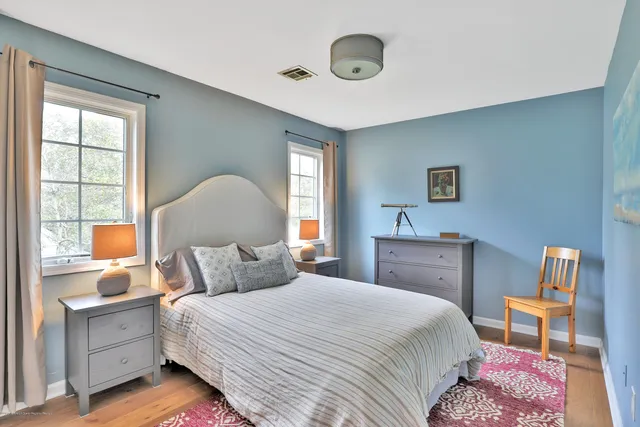 a bedroom with a bed and a lamp