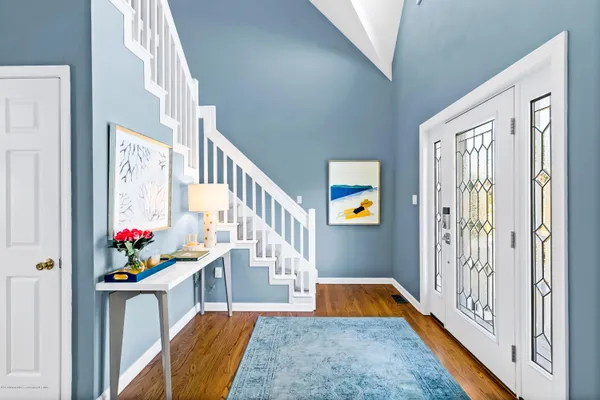 a view of an entryway with a table and chairs