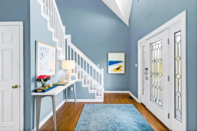a view of an entryway with a table and chairs