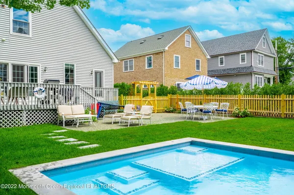 a front view of a house with a yard table and chairs