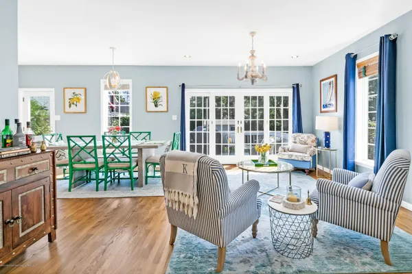 a living room with fireplace furniture and a wooden floor