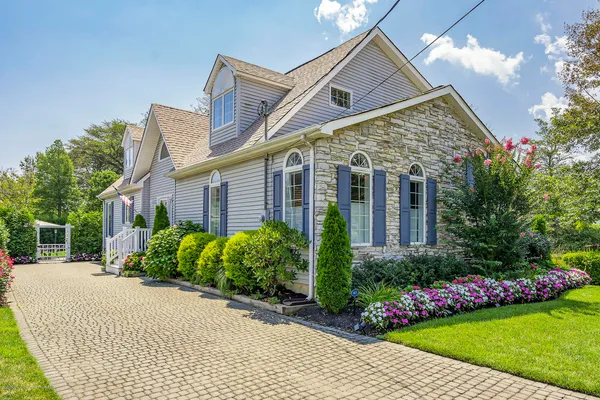 a front view of house with a garden