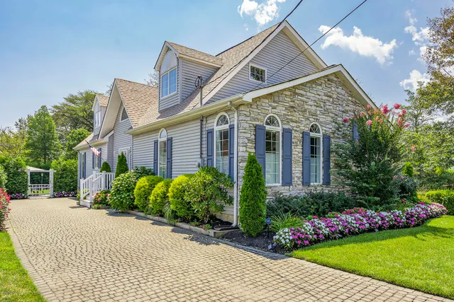 a front view of house with a garden