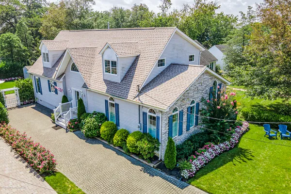 a aerial view of a house next to a yard
