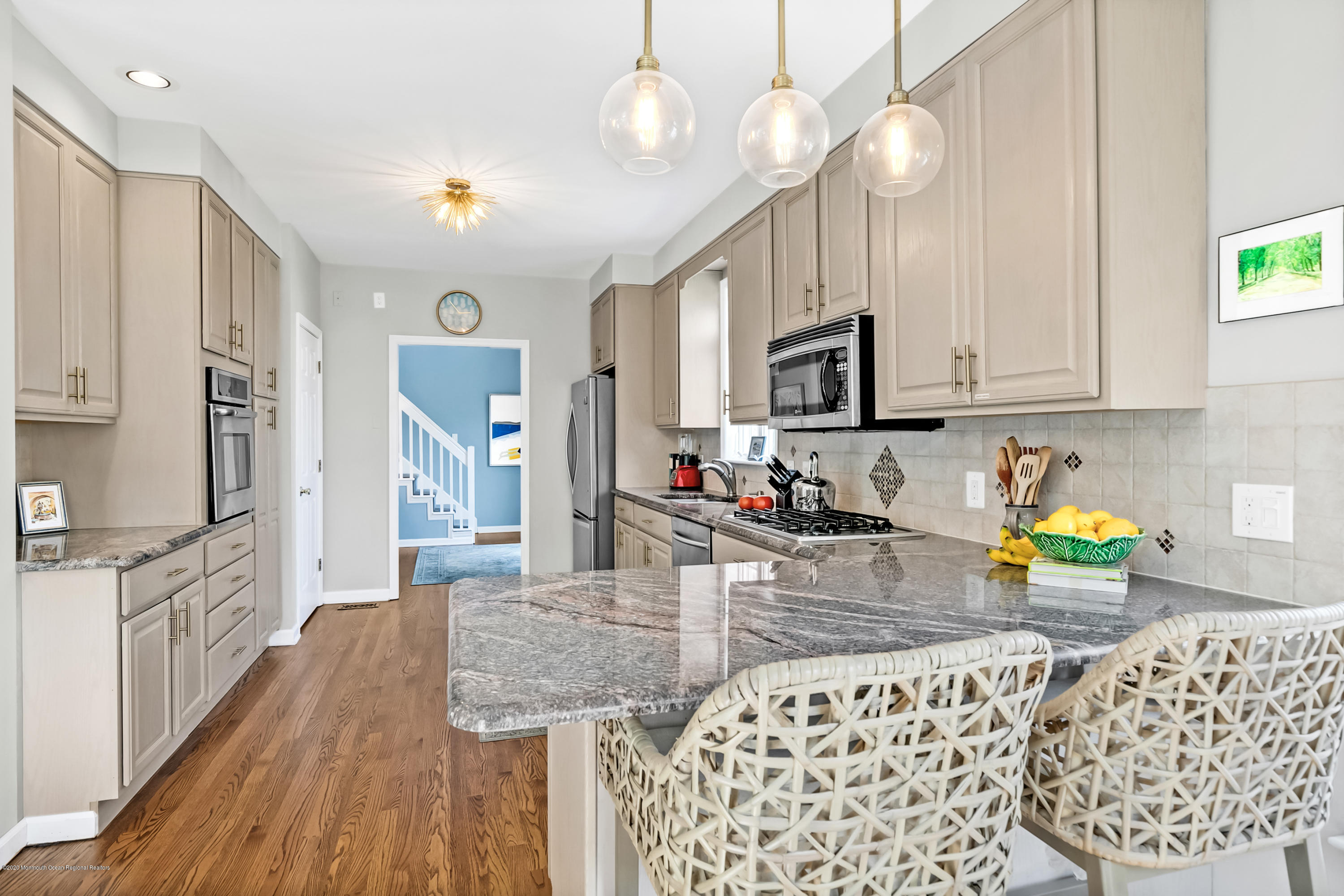 405 Salem Avenue, Unit SUMMER Spring Lake, NJ 07762 - Photo 5 of 46 a kitchen with stainless steel appliances granite countertop a sink dishwasher stove and microwave with wooden floor