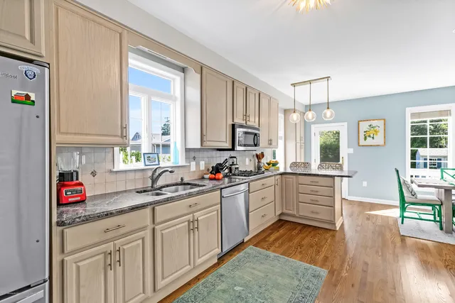 a kitchen with sink cabinets and wooden floor