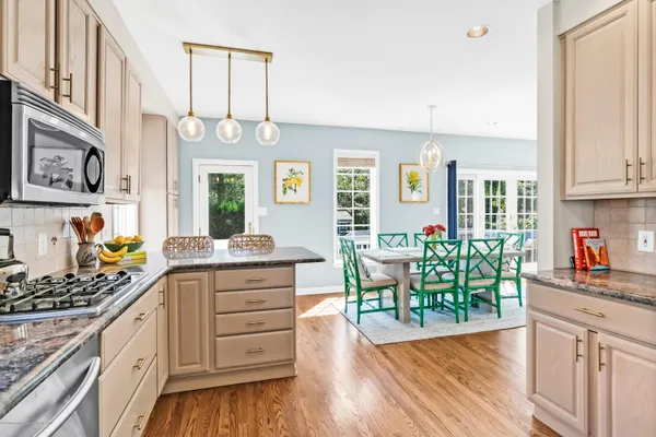 a kitchen with granite countertop cabinets a dining table and chairs