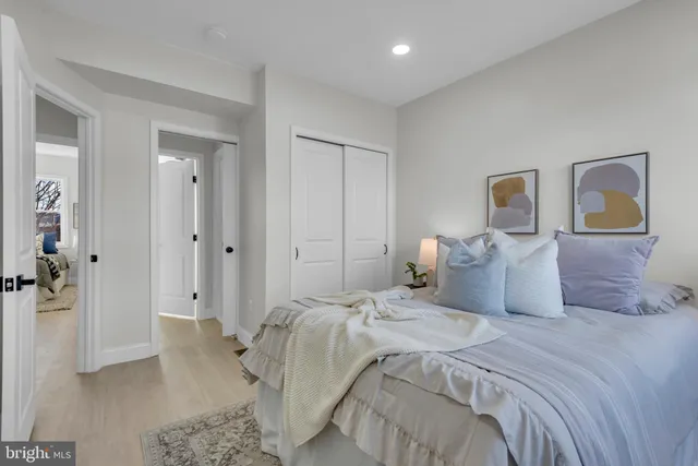 a bedroom with a bed and a painting