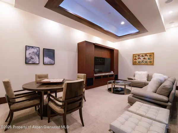 a living room with furniture a flat screen tv and a table