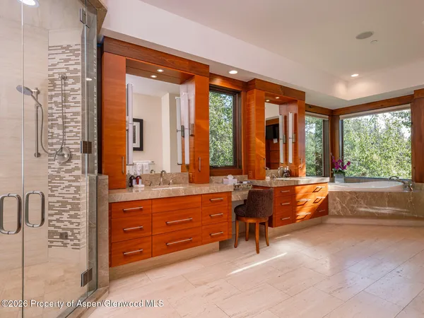 a spacious bathroom with a large tub and sink