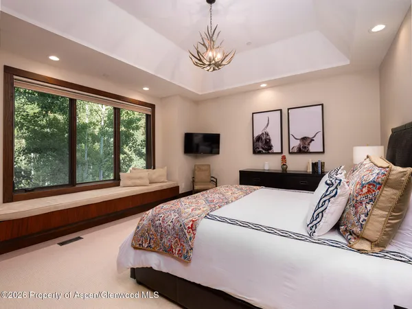 a bedroom with a large bed and a large window