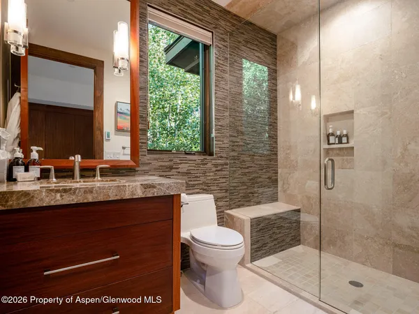 a bathroom with a toilet sink and shower