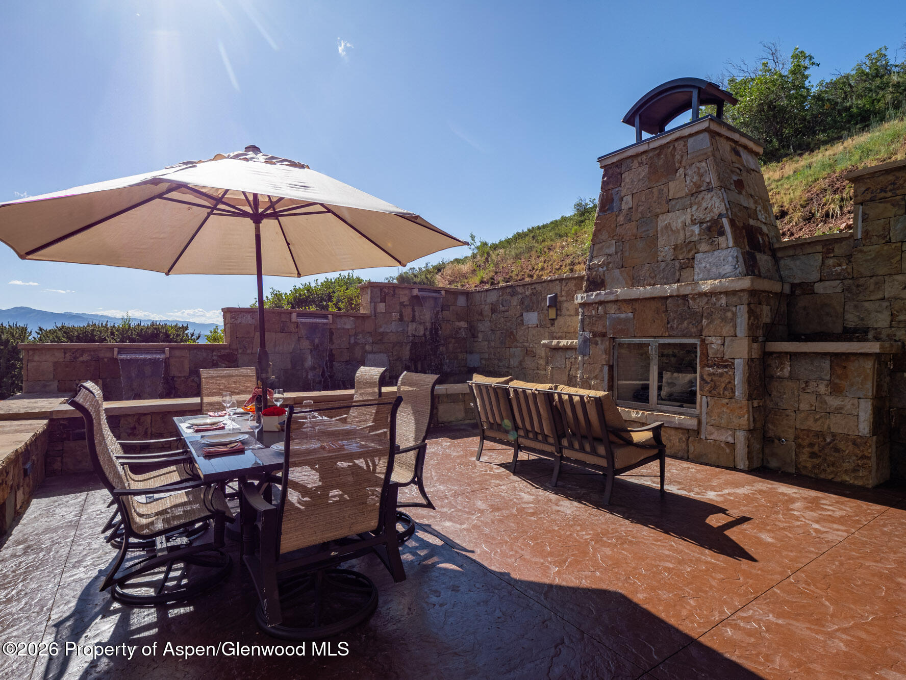 750 South Starwood Road Aspen, CO 81612 - Photo 30 of 39 a view of a roof deck with furniture and a umbrella