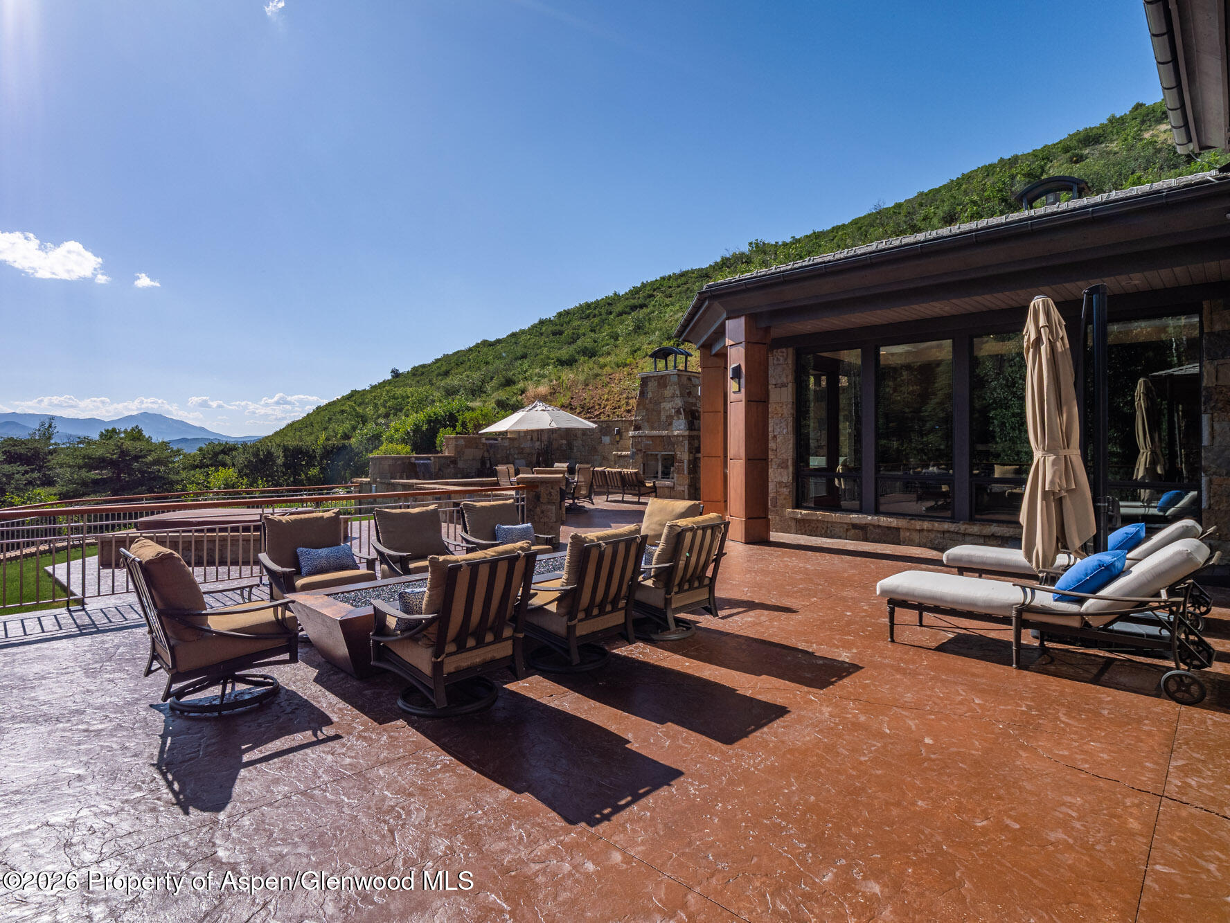 750 South Starwood Road Aspen, CO 81612 - Photo 33 of 39 a view of a patio with table and chairs and floor to ceiling window