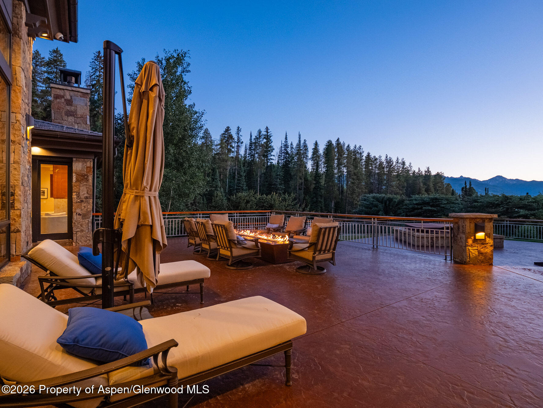 750 South Starwood Road Aspen, CO 81612 - Photo 37 of 39 a view of a swimming pool with couches chairs and a fire pit