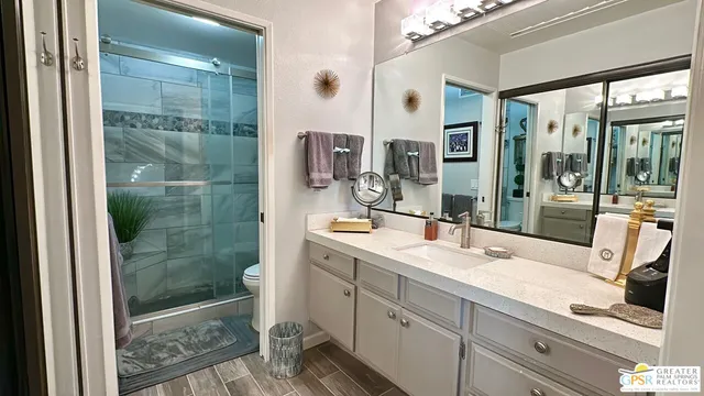a bathroom with a shower sink and mirror