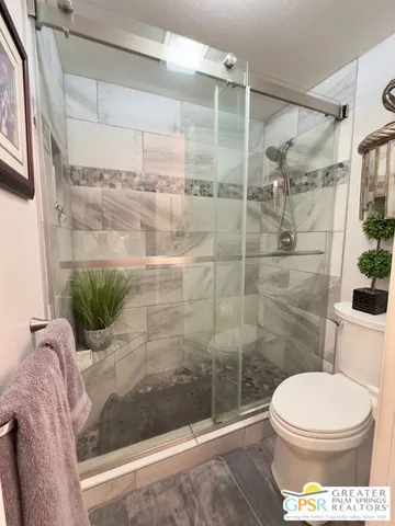 a bathroom with a toilet and a shower