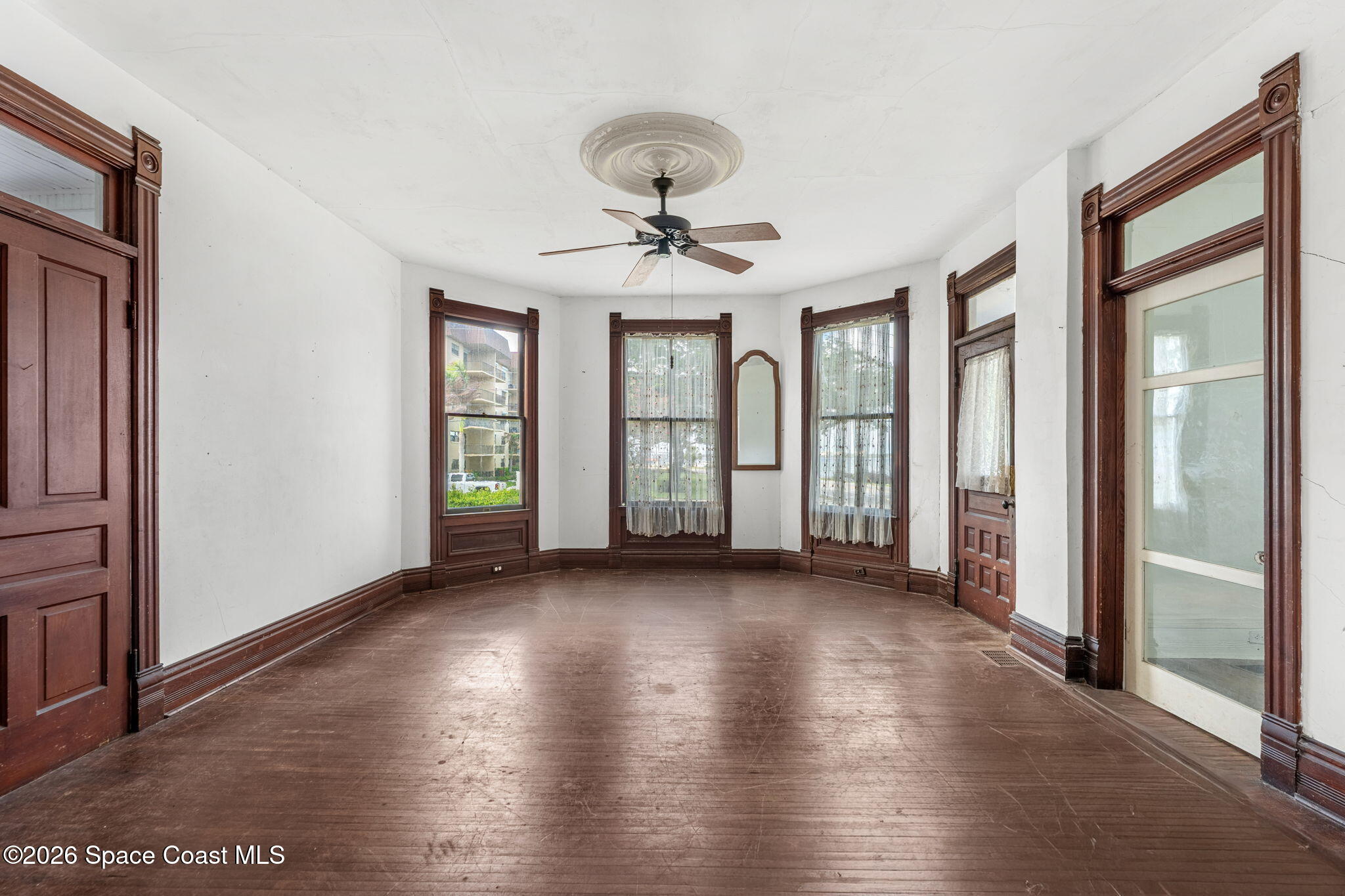 1101 Rockledge Drive Rockledge, FL 32955 - Photo 19 of 76 wooden floor in an empty room with a window