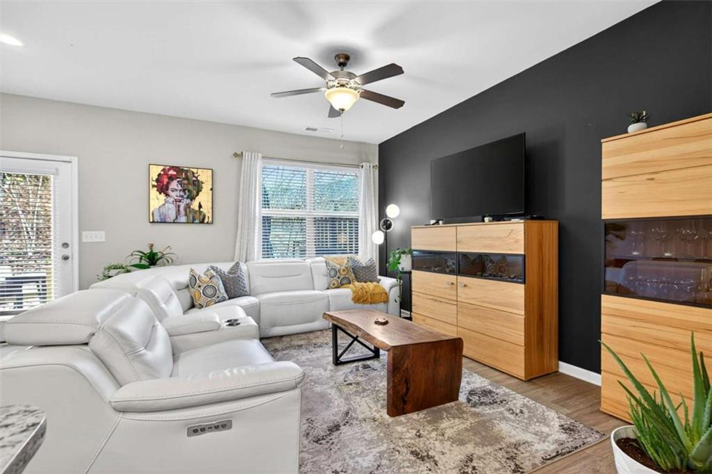 3182 Meadowstone Lane Southwest Atlanta, GA 30331 - Photo 11 of 32 a living room with furniture a flat screen tv and a fireplace