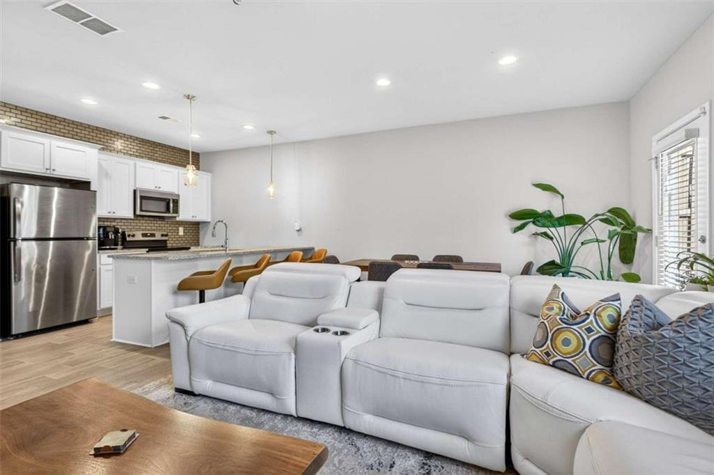 3182 Meadowstone Lane Southwest Atlanta, GA 30331 - Photo 12 of 32 a living room with furniture and a refrigerator