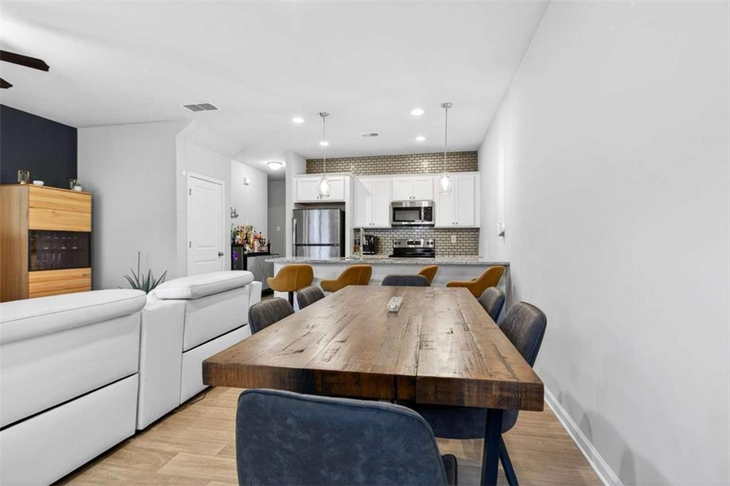 3182 Meadowstone Lane Southwest Atlanta, GA 30331 - Photo 13 of 32 a living room with stainless steel appliances furniture a rug and a kitchen view